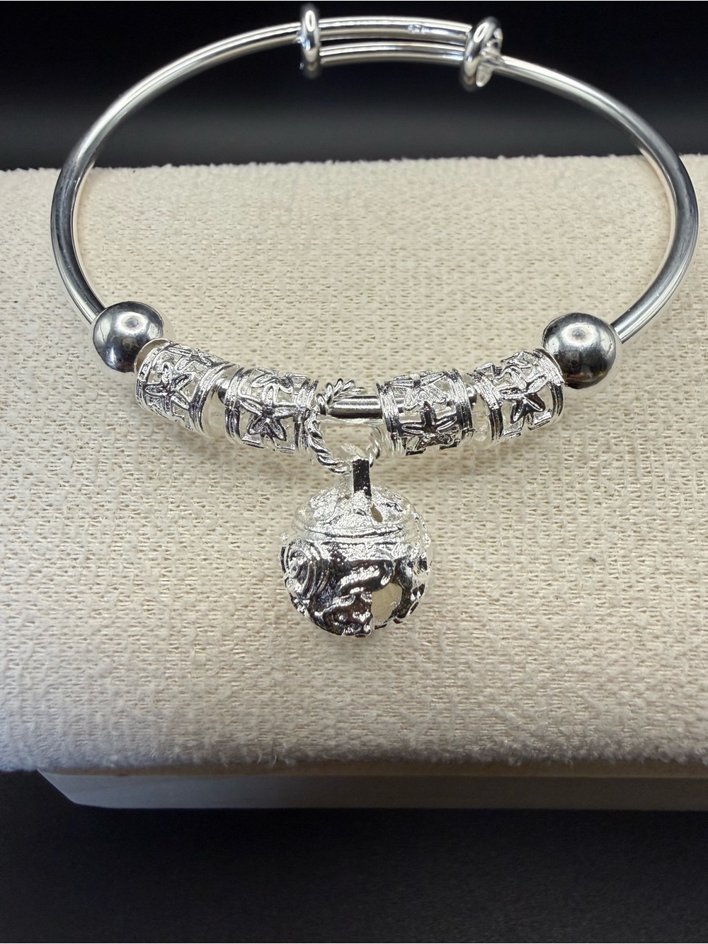 Stainless steel bracelet with jingle bell charm